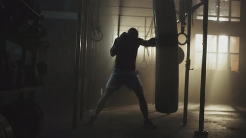 Man Training Hard, Punching a Heavy Bag