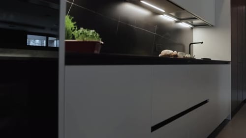 Experience the Beauty of Modern Kitchen Design Adorned with Sleek Finishes and Stylish Lighting
