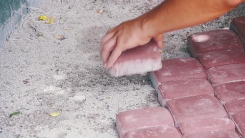 Worker is Laying Paving Stones Using Hammer Slow Motion