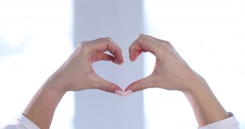 Woman's Hands Forming a Heart Shape with Fingers