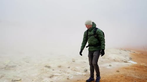 Man Walking Through The Steam At Myvatn Iceland