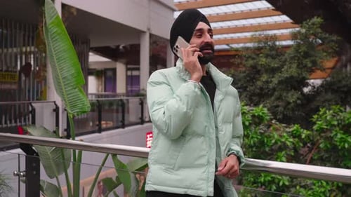 Smiling Man Talking on Phone Outdoors