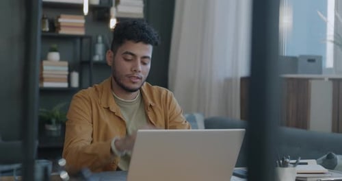 Man Works at Laptop From Home Office
