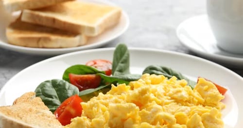 Scrambled Eggs with Toast and Spinach on Plate