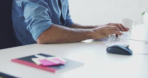 4K closeup video footage of a man working on a computer in a modern office