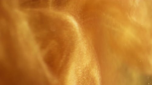 Abstract liquid gold flowing with glittering particles