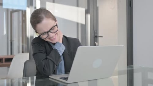 Woman Experiencing Neck Pain at Office Desk