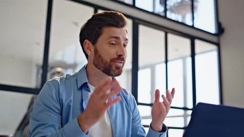 Man Talking on Video Conference at Workplace