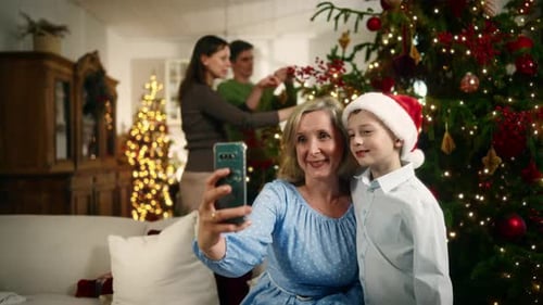 Grandmother and Grandson Take a Selfie at Christmas