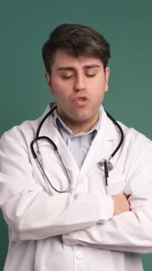 Angry Stressed Young Doctor Man Shouting Isolated Over Green Background