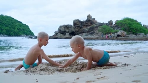 Boys Playing Together on Sandy Tropical Beach