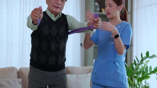 Senior Man Exercising with Resistance Band at Home