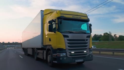 Cargo truck with copy space for advertising on white semi-trailer driving on highway