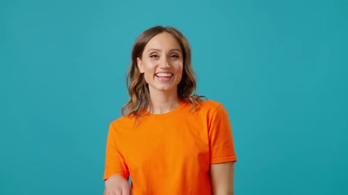 Cheerful Woman Smiles and Poses in Studio