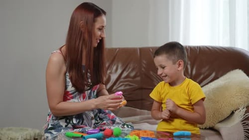 Mother and Child Playing with Modeling Clay Indoors