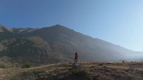 Aerial View Young hiker walking on a mountain path on a sunny day