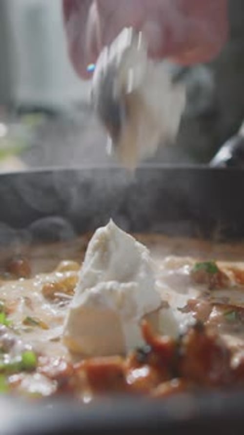 Unrecognizable Chef Adding Cream Cheese into Chicken Stew
