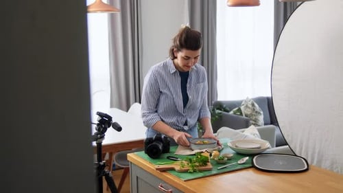 Woman Arranges Food For Camera in Home Studio