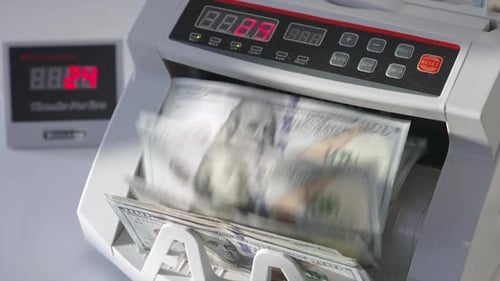 Automatic cash machine for bank operations. Modern device counting one hundred dollar bills.
