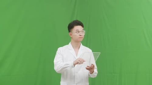Portrait Scientist male researcher with protective glasses mask examining lab tube with a blue fluid
