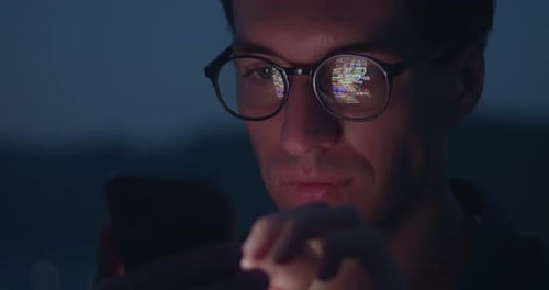 Close Up Male in Glasses Scroll Page App on Mobile Phone Browse Social Network Mobile Screen