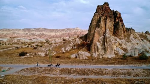 People Horseback Riding Through a Natural Rock Formation
