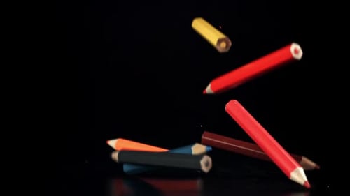 Colored Pencils Falling on a Table on a Black Background Filmed on a Highspeed Camera at 1000 Fps