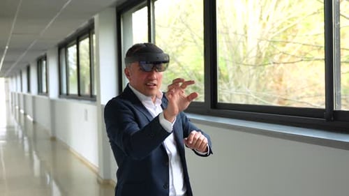 Businessman Using VR Simulator in the Corridor of a Building