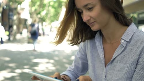 Young businesswoman enjoying coffee and tablet technology in the city cafe
