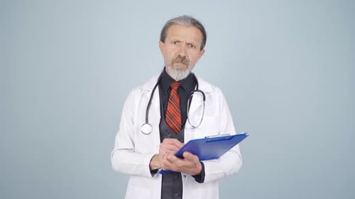Doctor Gesturing and Speaking with Clipboard