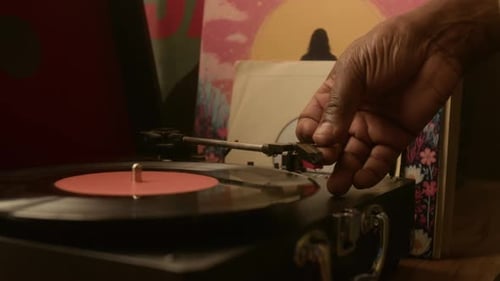 Close-up of Hand of Unrecognisable Man Lowering Tonearm on Vinyl Record Player