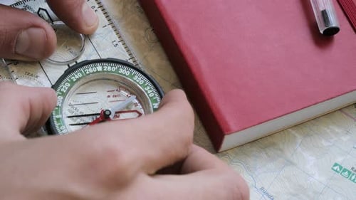 Hiker setting compass from a map
