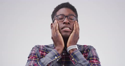 Man Rubbing Temples in Discomfort