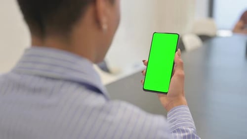 Holding Phone with Chroma Key on the Screen