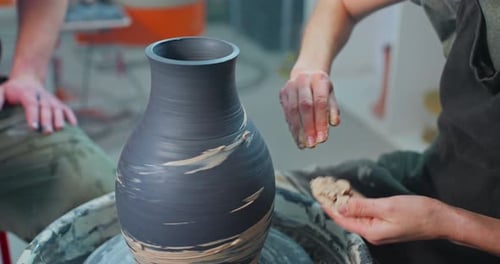Artist Creating Clay Pottery on a Wheel