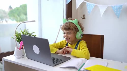Boy Learning Online with Laptop at Home