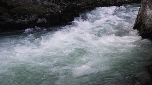 Fast Flowing Water Of Mountain River In British Columbia, Canada. - wide shot