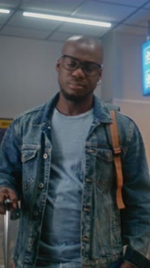 International Airport Terminal Man with Luggage Sitting Waiting for Airplane Flight