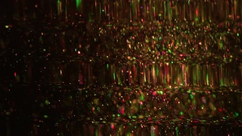 Sparkling Colorful Particles Floating Upward in Dark Background