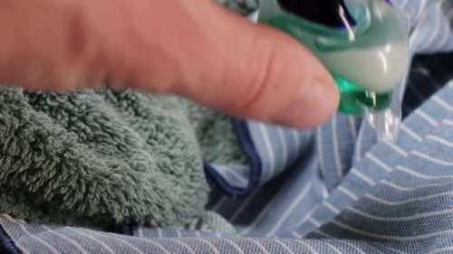 Laundry Detergent Pod on Colorful Towels