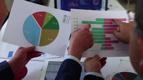 Stockbroker Analyzing Company Financial Statement Performance Data Chart