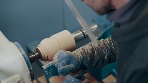 Woodworker Shaping Wood on a Lathe