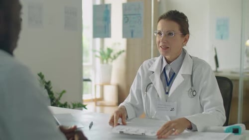 Doctor Explains Medical Report to Patient in Office