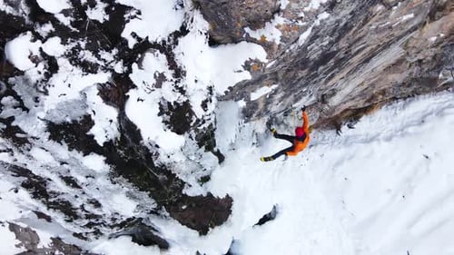 Ice Climber Ascending Frozen Mountain Landscape