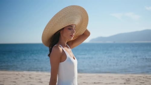 Carefree Traveler Walking Sea Beach in Straw Hat Closeup Luxurious Woman Posing