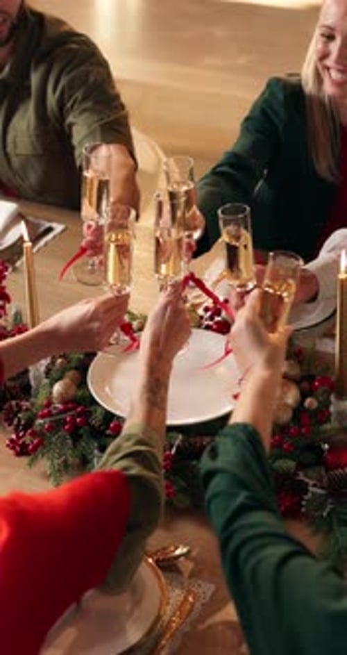 Friends Celebrate Together Clinking Champagne Glasses at Holiday Table