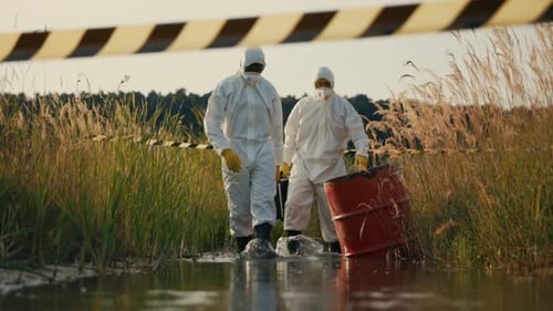 Scientists Wearing Hazmat Suits Walk Through Swamp