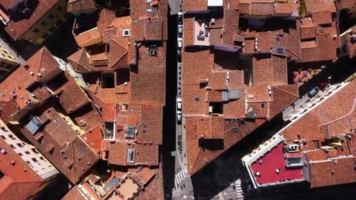 Static top down view of roofs, roads and city on a sunny day in Florence in Italy in 4k.