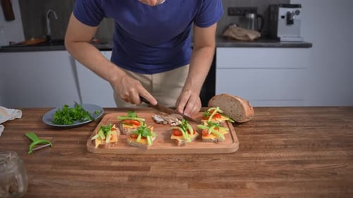 Man preparing tasty sandwiches in a modern kitchen