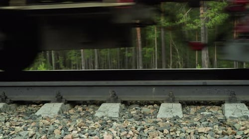 CloseUp of Train Wheel Passing Over Railroad Tracks in Motion Blur